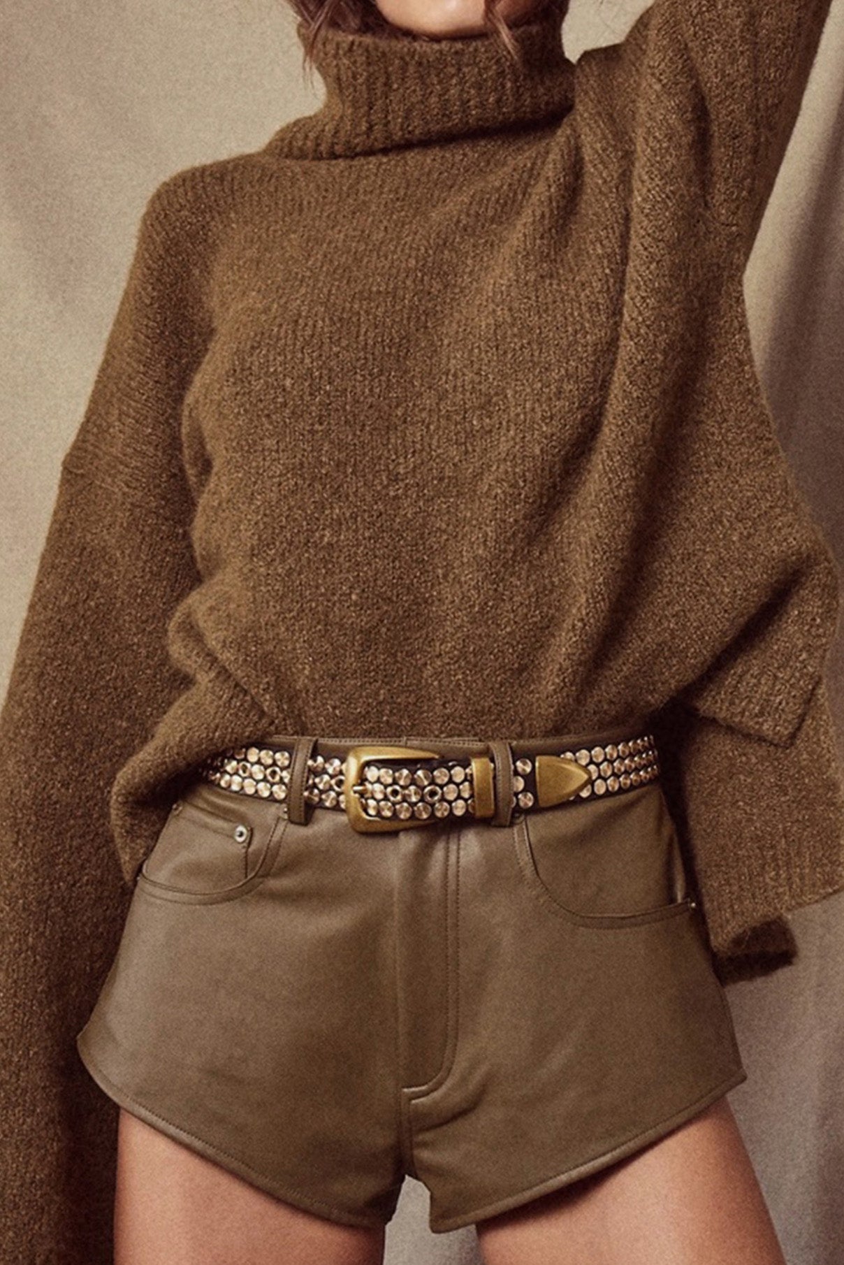 Close-up of the Colton dark brown leather belt showing stud pattern and gold buckle.