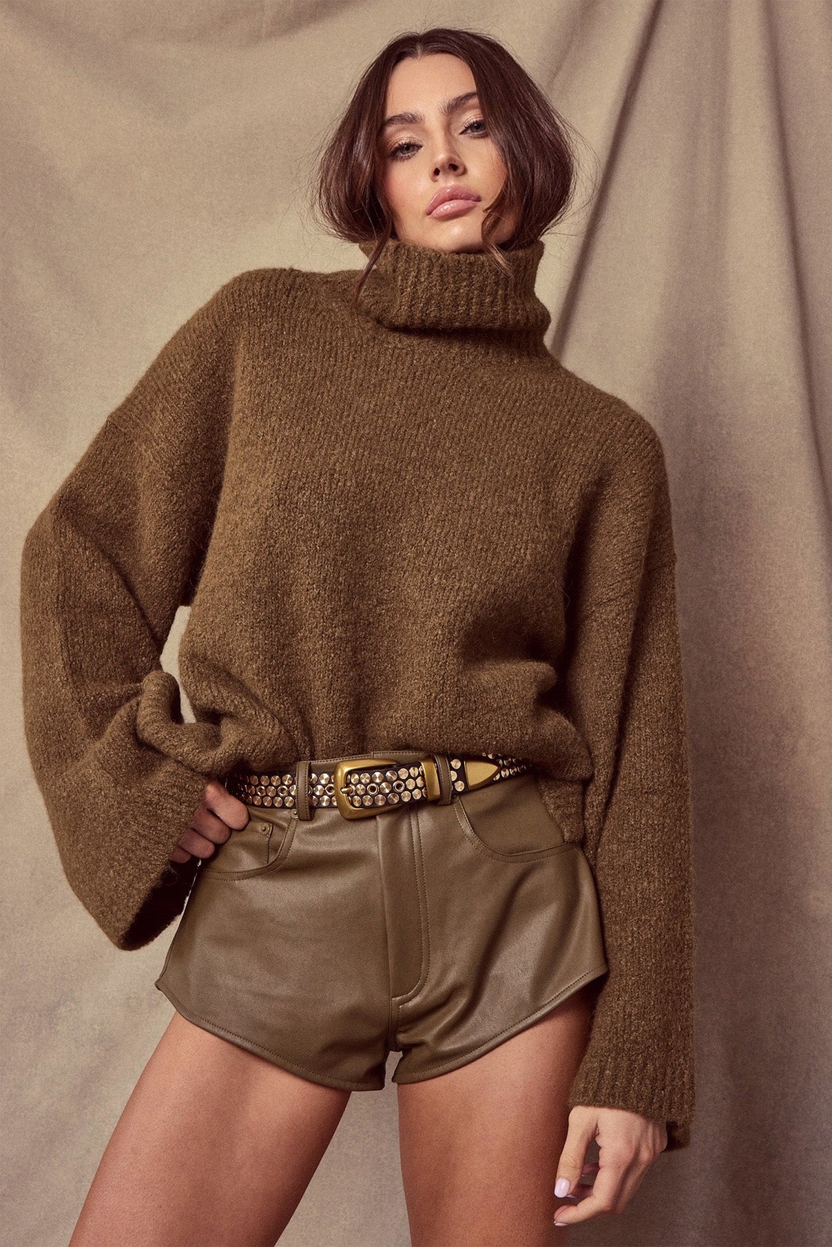 Model wearing the Colton dark brown studded leather belt styled at the waist.