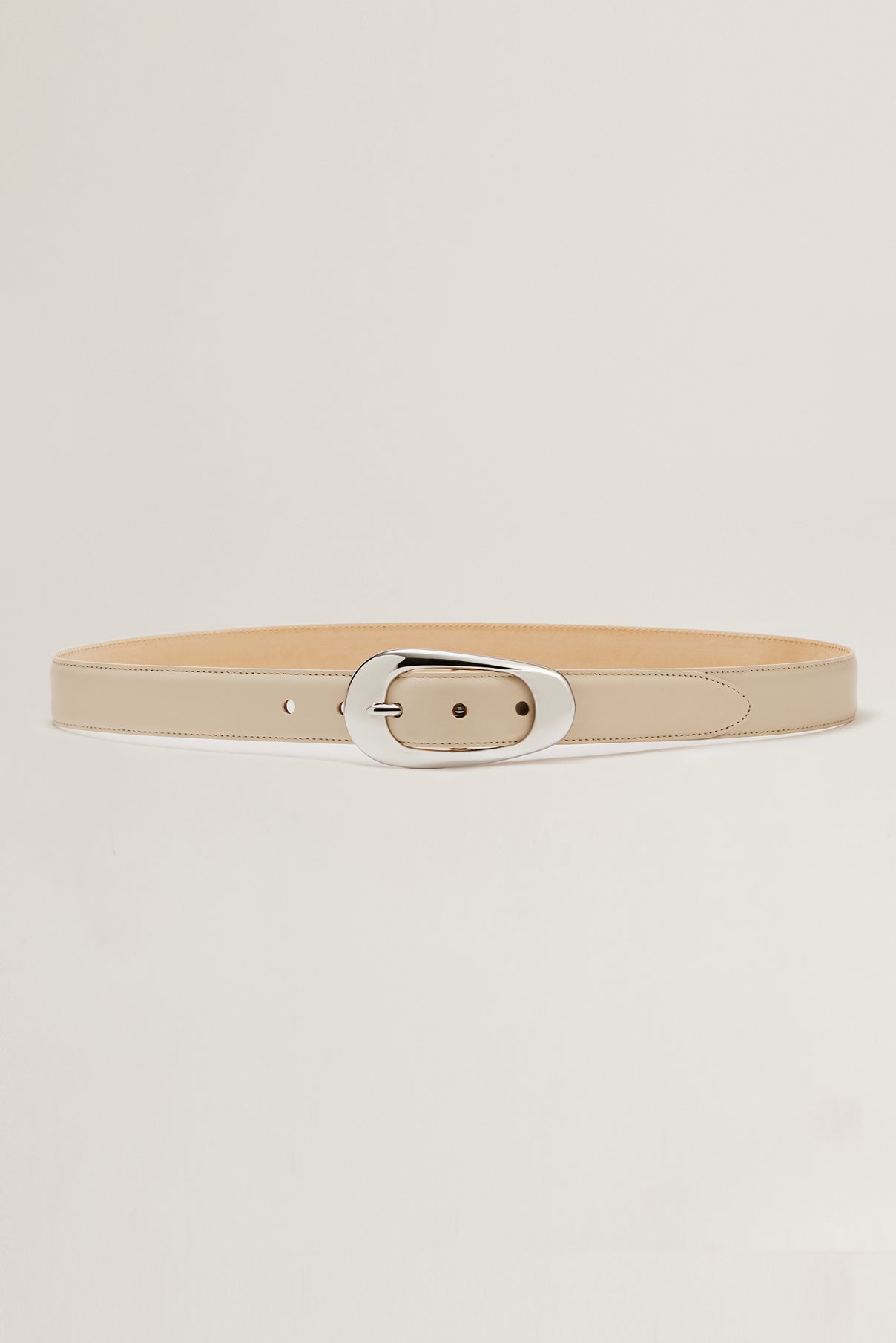 Devyn creme leather belt displayed rolled to show silver buckle and smooth leather.