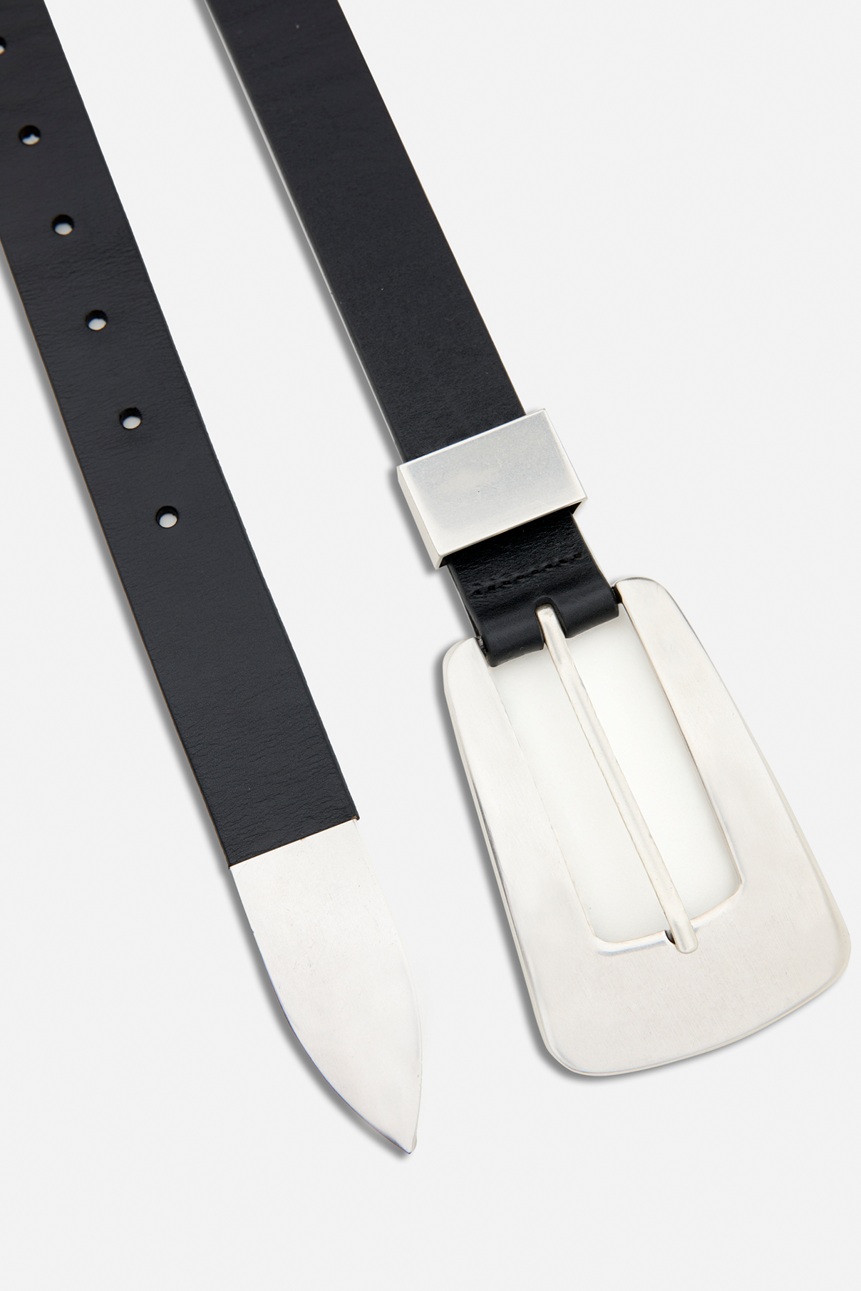 Close up flat lay of the Logan black vintage leather belt highlighting sculptural silver buckle.
