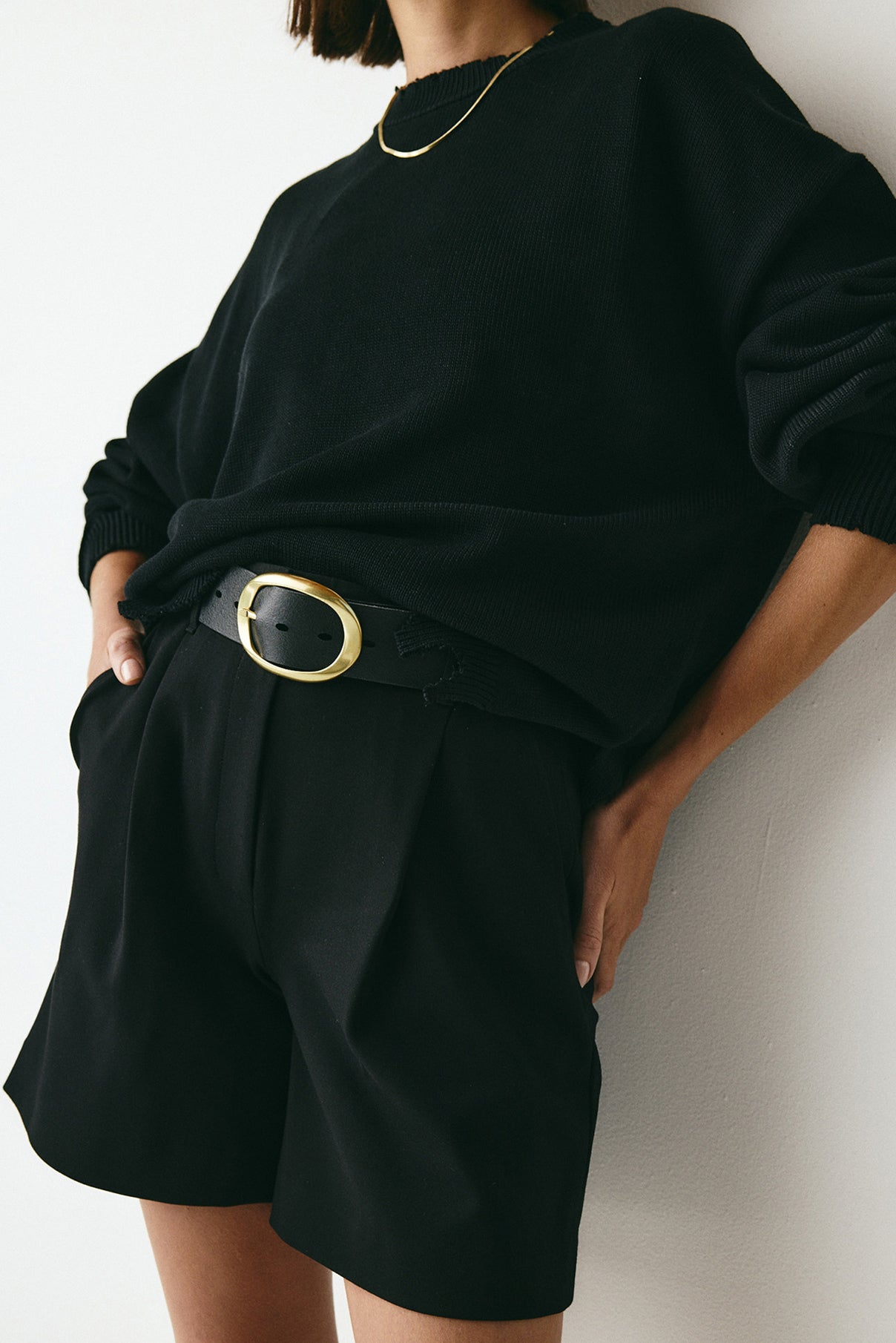 Model wearing the Brooklyn black leather belt styled at the waist.