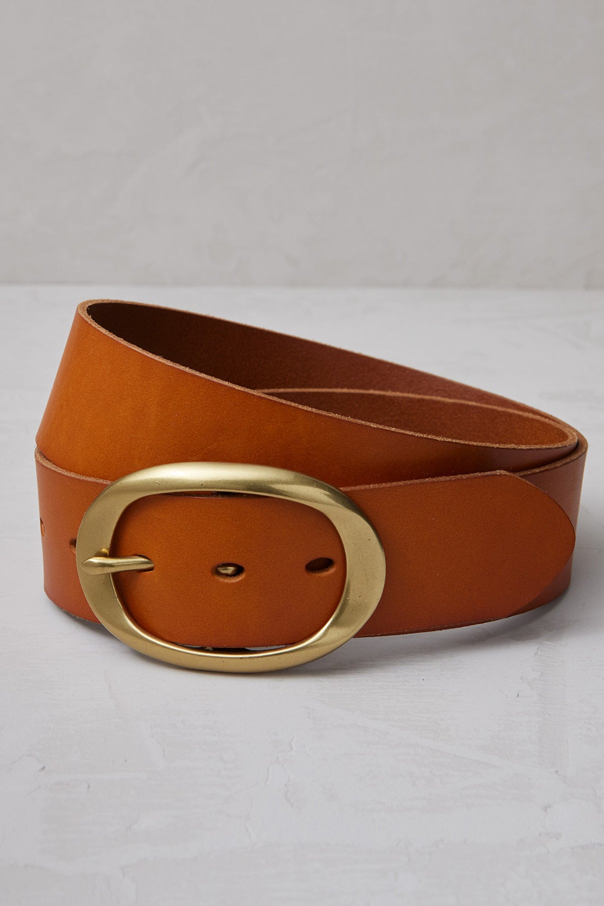 Coiled Brooklyn vachetta leather belt with polished gold buckle.