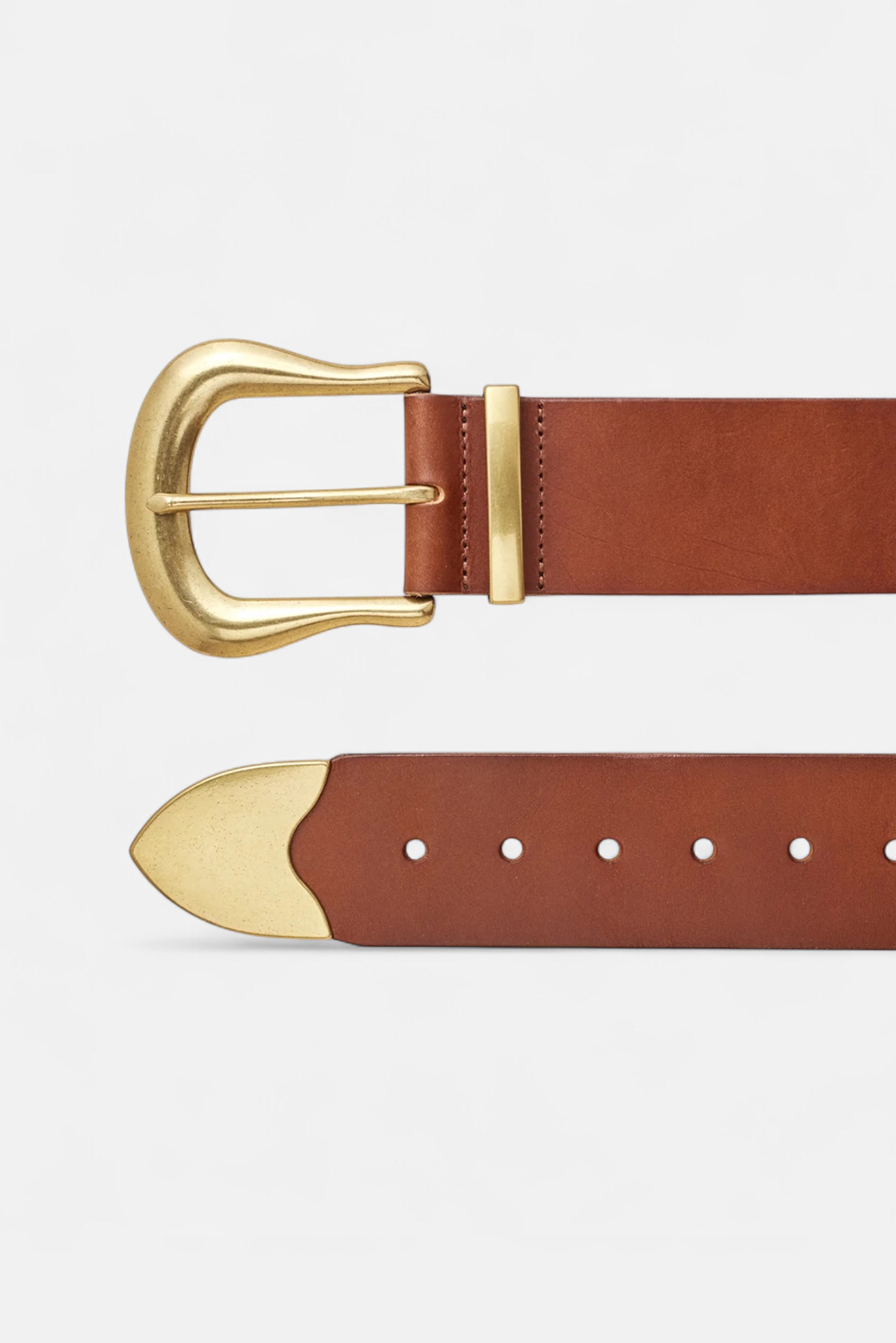 Zoomed in flat lay of the Maylee cognac leather belt with sculptural gold hardware visible.